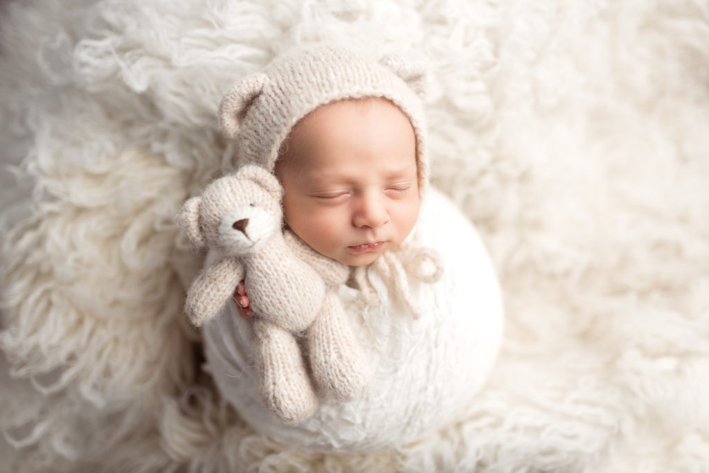 newborn baby with teddy bear