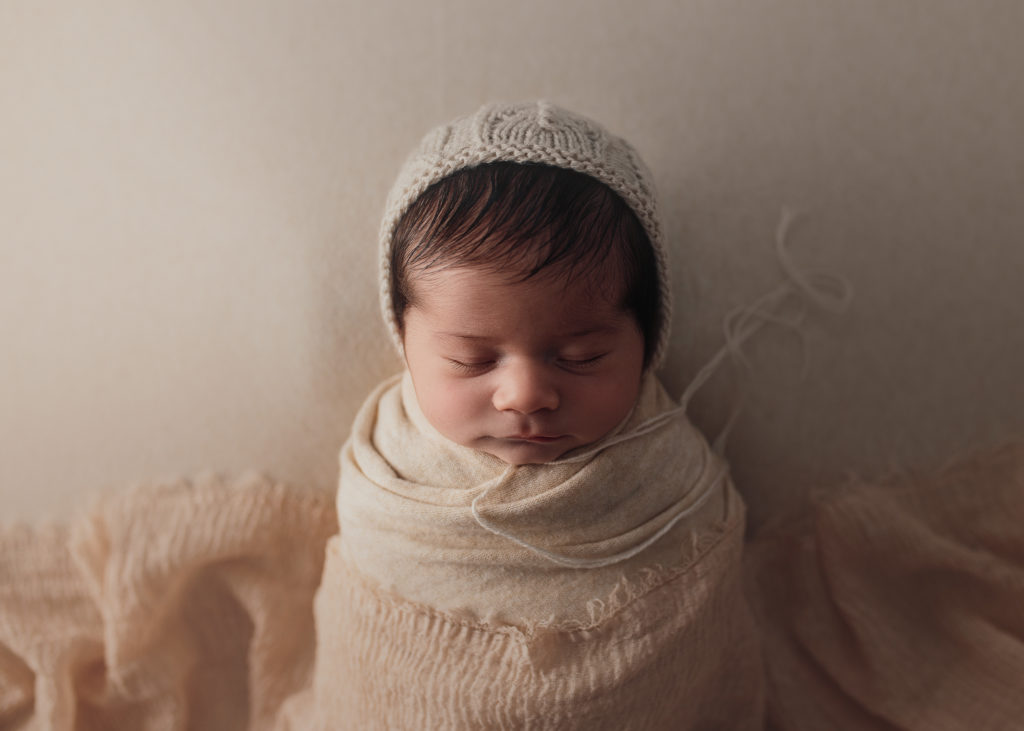 newborn baby in bonnet