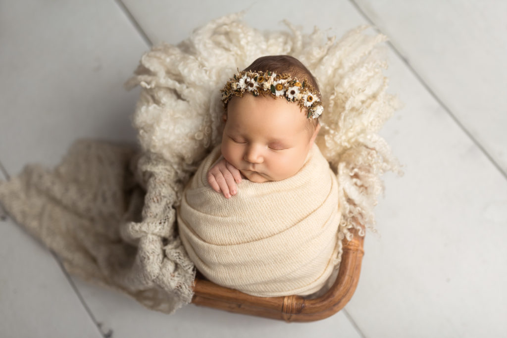 baby in basket cream flower crown
