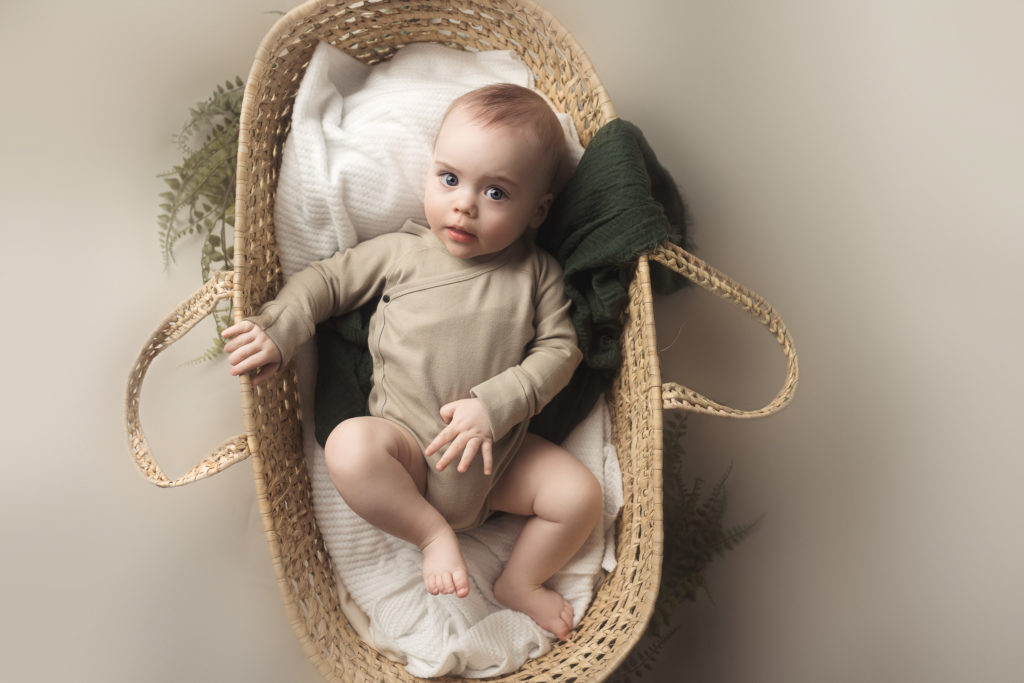 baby boy in moses basket